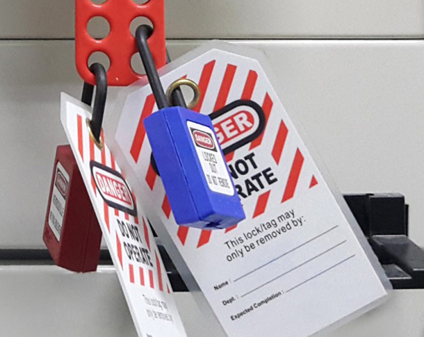 Image of LOTO lock and tag used during industrial lockout/tagout.